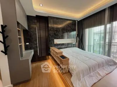 Luxurious modern bedroom with elegant lighting and balcony view, featuring sleek design and cozy ambiance.