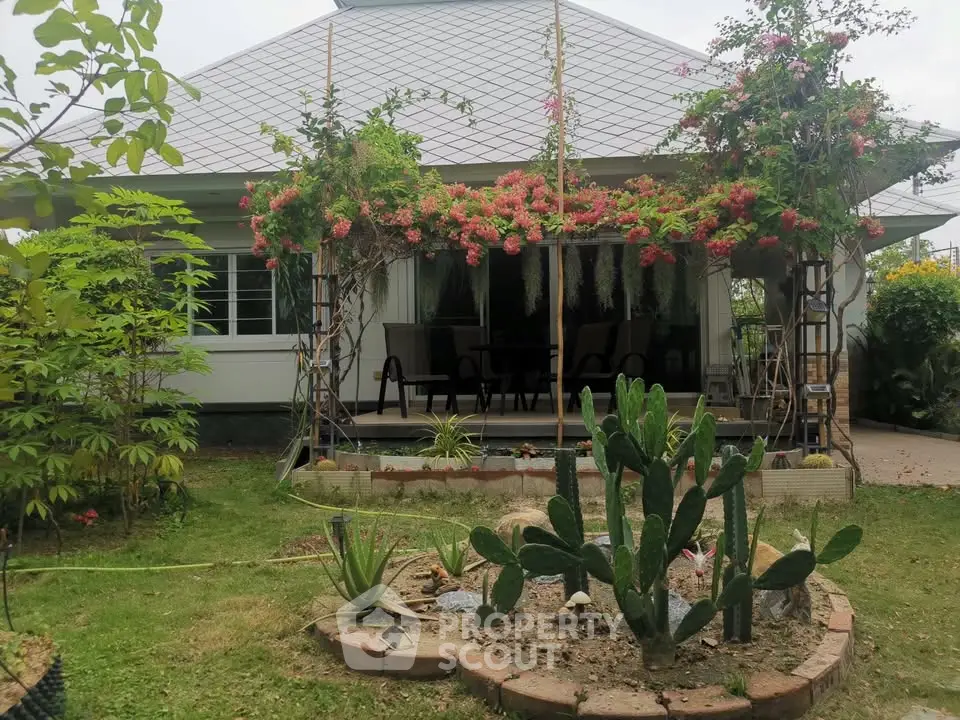 Charming single-story house with lush garden and blooming flowers, perfect for nature lovers seeking tranquility.