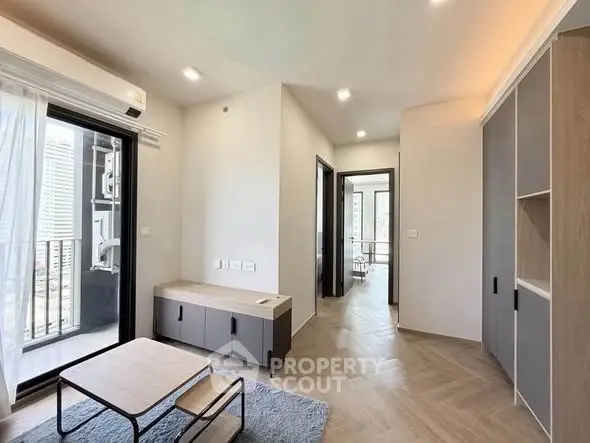 Modern living room with balcony access and stylish furniture in a contemporary apartment.
