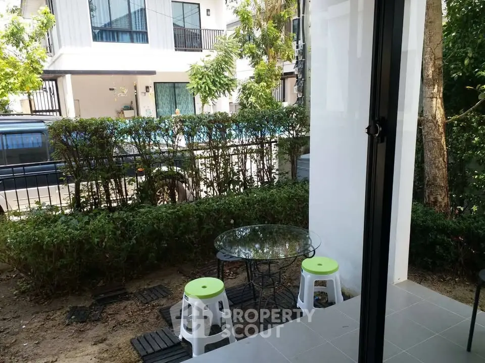 Charming garden view with cozy outdoor seating area in modern residential setting.