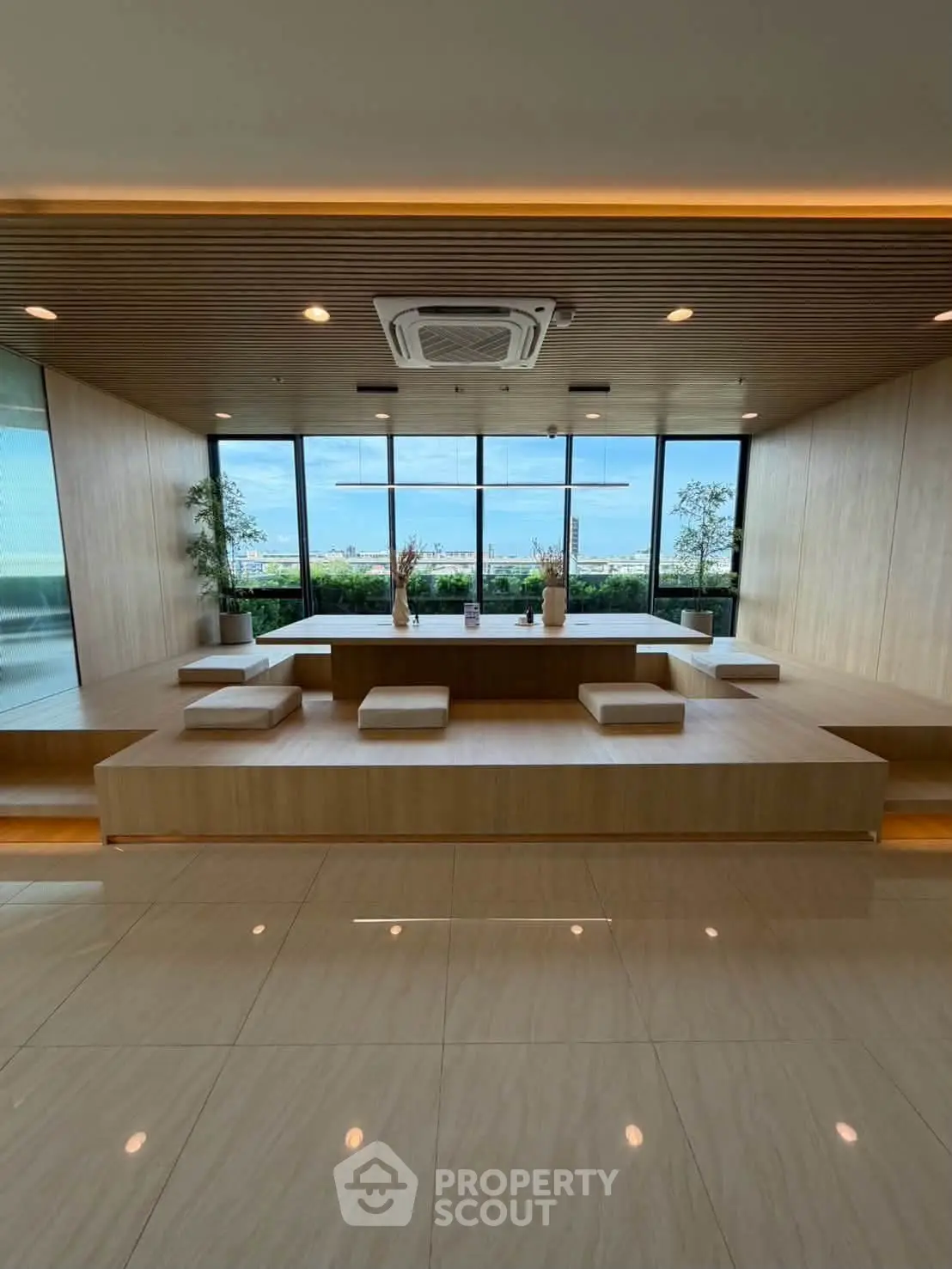Luxurious modern lobby with panoramic windows and elegant seating area.