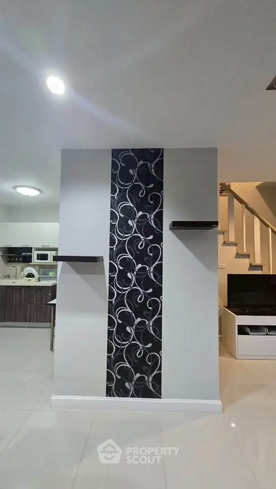 Modern interior with stylish wall design and open kitchen layout
