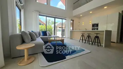 Spacious modern living room with open kitchen and stylish decor