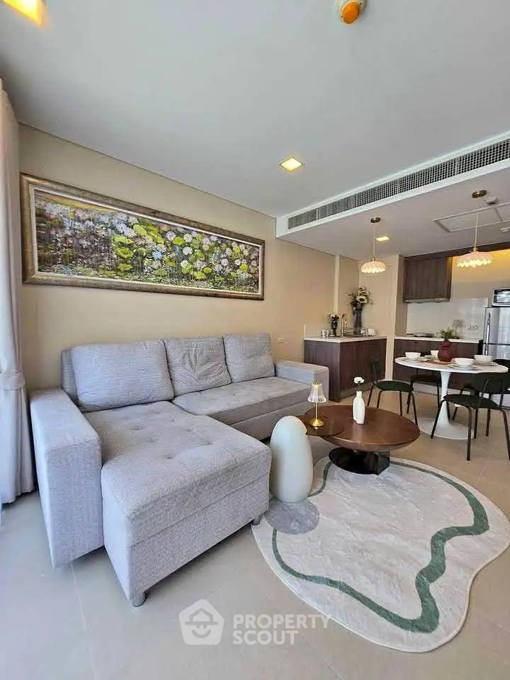 Modern living room with stylish decor and open kitchen layout in a contemporary apartment.