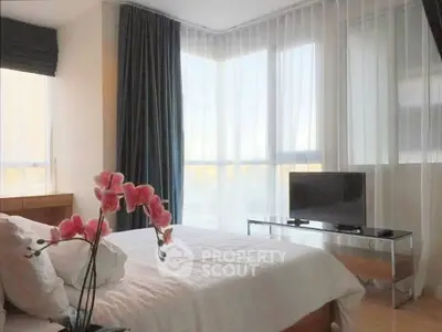 Bright and modern bedroom with large windows and stylish decor