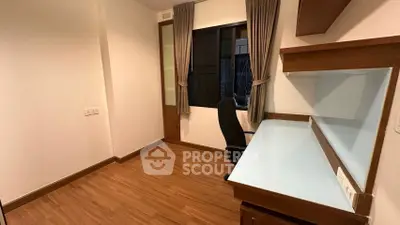 Modern study room with wooden flooring and built-in desk, ideal for productivity.