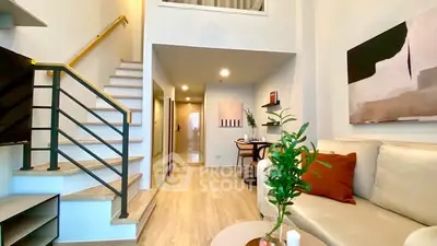 Modern duplex living room with stylish decor and open staircase