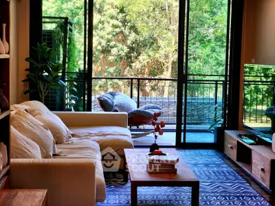 Chic living room with cozy sofa and lush balcony view, perfect for relaxation.