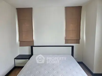 Minimalist bedroom with modern bed frame and dual window shades