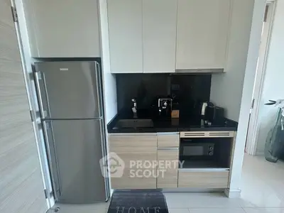 Modern compact kitchen with sleek appliances and stylish cabinetry