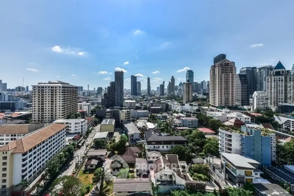 Stunning cityscape view showcasing urban skyline and residential buildings under a clear blue sky.