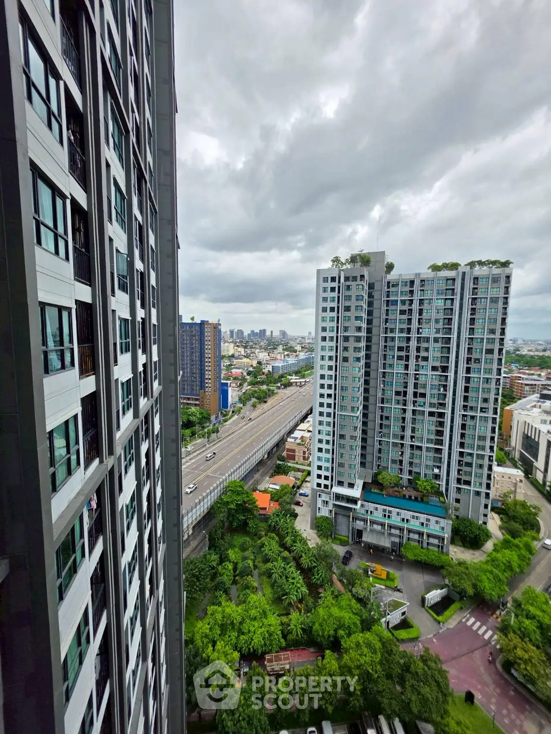 Stunning high-rise apartment view with lush greenery and cityscape