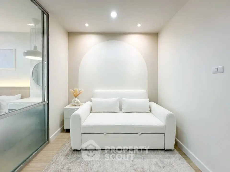 Modern minimalist living room with white sofa and soft lighting