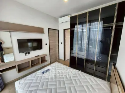 Modern bedroom with sleek wardrobe and wall-mounted TV