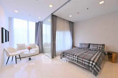 Spacious modern bedroom with elegant decor and natural light