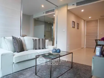 Modern living room with sleek furniture and glass coffee table in a stylish apartment.