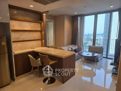 Modern open-layout living room with city view and stylish kitchen area