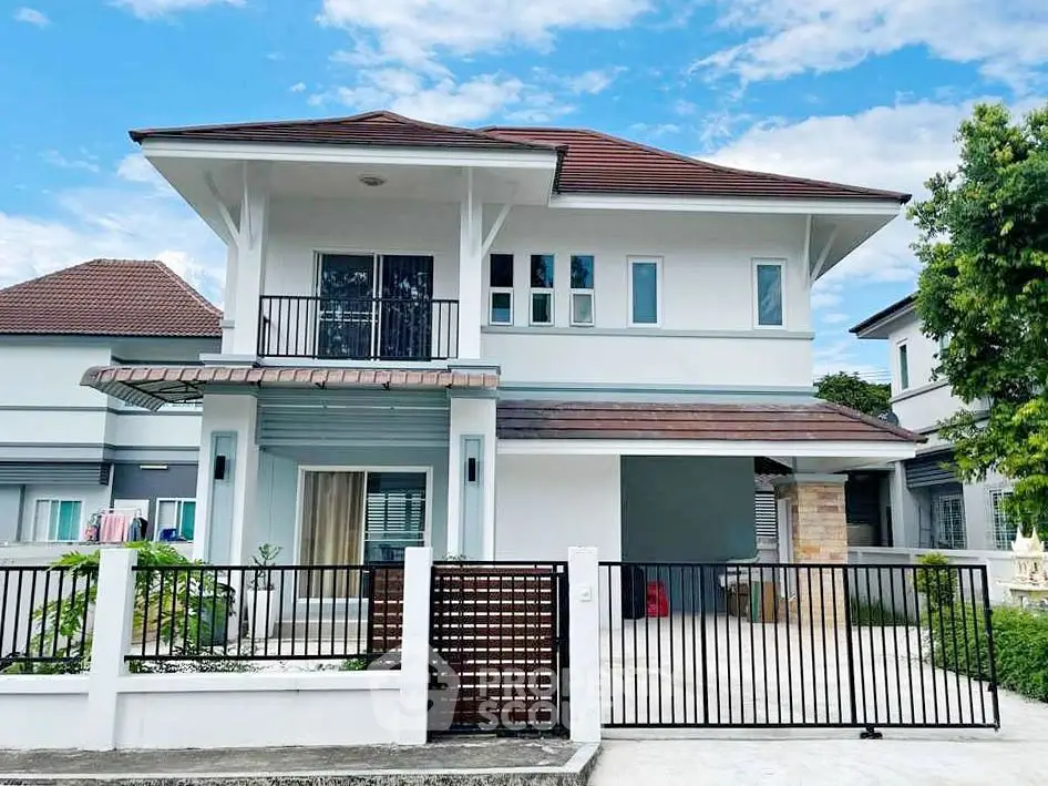 Modern two-story house with a spacious driveway and elegant design.