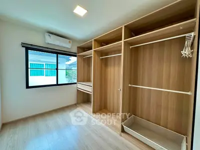 Spacious walk-in closet with wooden finish and ample storage space
