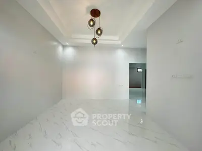 Spacious modern living room with elegant lighting and marble flooring