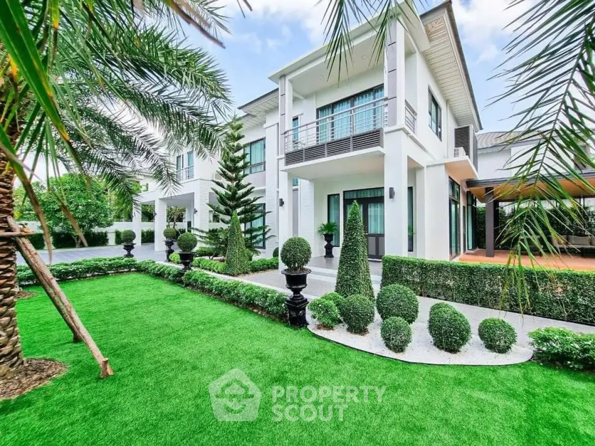 Luxurious modern home with manicured garden and elegant exterior design.