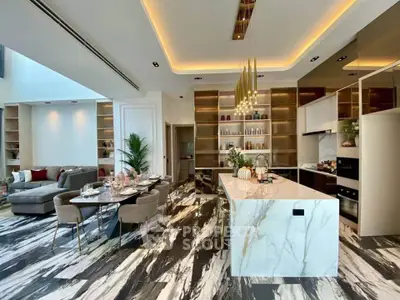 Luxurious open-plan kitchen and living area with modern design and elegant lighting