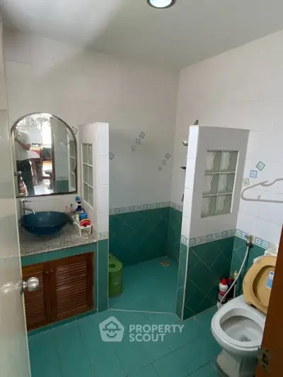 Charming bathroom with unique tile design and modern fixtures.