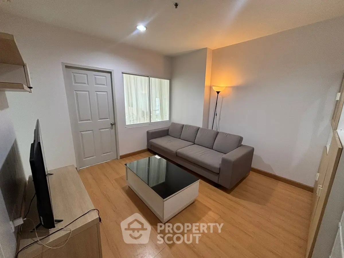 Modern living room with sleek furniture and warm lighting, perfect for relaxation.