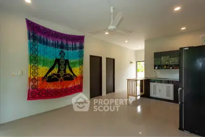 Spacious open-plan living area with modern kitchen and vibrant wall art