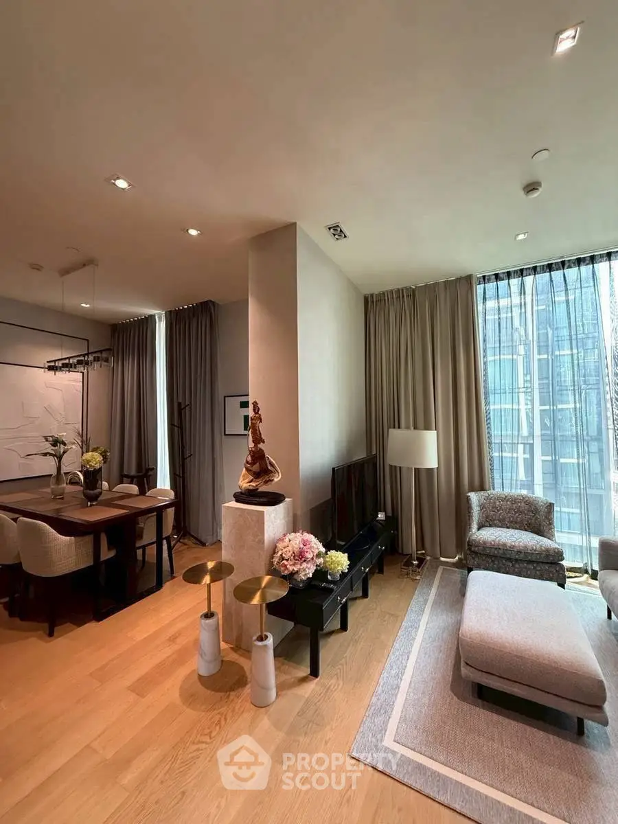 Luxurious modern living room with elegant decor and large windows offering stunning city views.