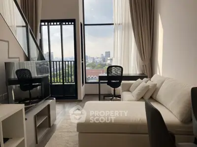 Spacious modern living room with large windows and city view, perfect for urban living.