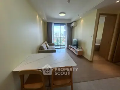 Modern living room with balcony view in a high-rise apartment