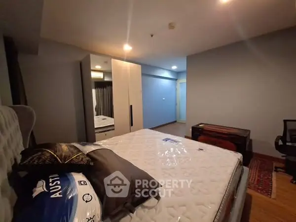 Spacious bedroom with modern decor and ample storage space