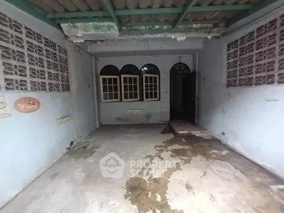 Spacious garage with vintage windows and rustic charm, perfect for storage or renovation.