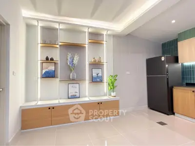 Modern kitchen with sleek cabinetry and decorative shelving, featuring a spacious layout and contemporary design.