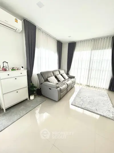 Spacious living room with modern sofa and natural light