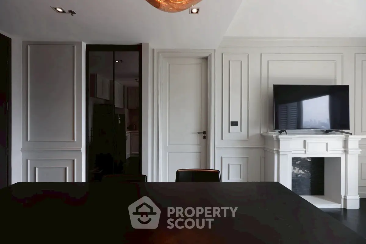 Elegant living room with modern TV setup and stylish paneling