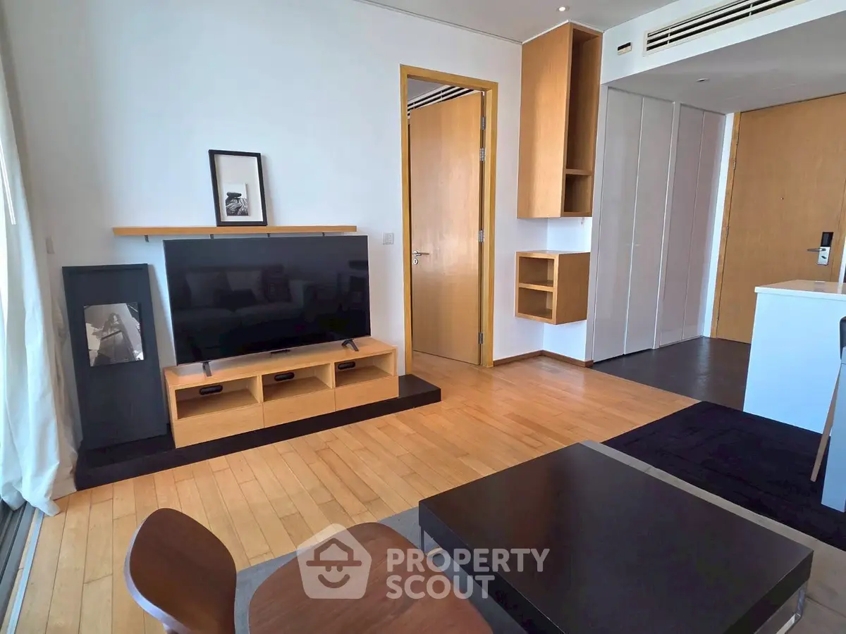 Modern living room with sleek wooden flooring and stylish furniture