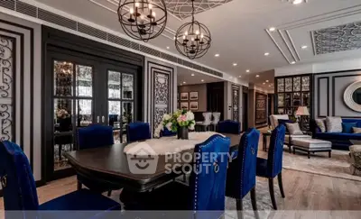 Luxurious dining and living area with elegant decor and plush blue chairs, perfect for sophisticated gatherings.