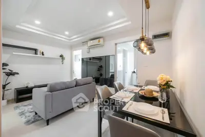 Modern living room with sleek dining area and stylish decor in a contemporary apartment.