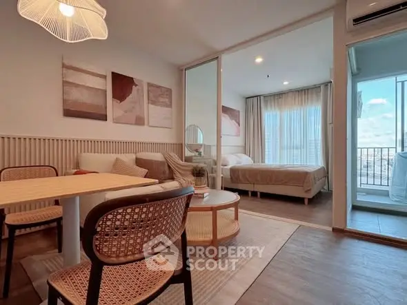 Modern open-plan living room with cozy bedroom and balcony view