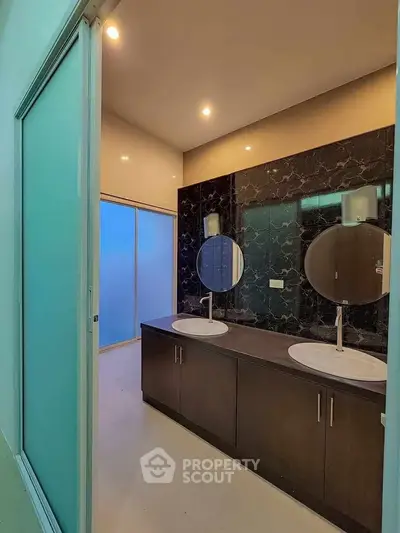 Modern bathroom with dual sinks and elegant black marble wall