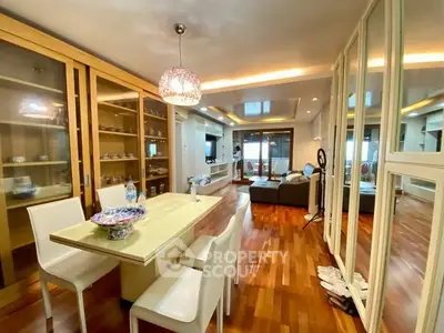 Spacious open-plan living and dining area with modern decor and hardwood floors.