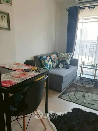 Cozy living room with modern decor and balcony view in urban apartment