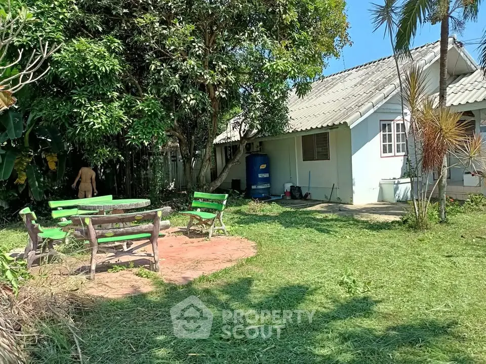 Charming countryside home with lush garden and outdoor seating area, perfect for relaxation and nature lovers.