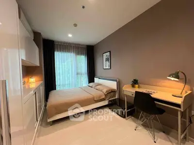 Modern bedroom with study area, featuring sleek furniture and large window for natural light.