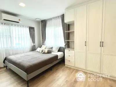 Spacious bedroom with modern decor and ample natural light