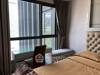Modern bedroom with city view, featuring a cozy bed and a stylish work desk by the window.