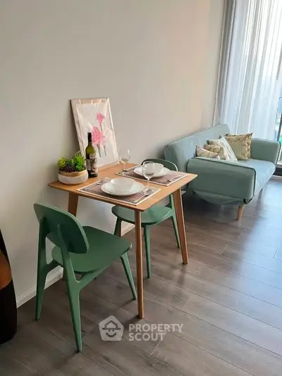 Chic modern living room with stylish dining setup and cozy seating area.
