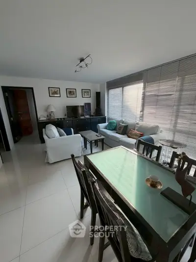 Spacious living room with modern decor and ample natural light